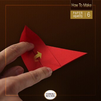 Place one finger between the fold on the left point of the triangle and press down. Then, fold the middle point on itself. This should produce a small cup on the left side.