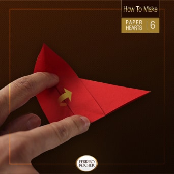 Place one finger between the fold on the left point of the triangle and press down. Then, fold the middle point on itself. This should produce a small cup on the left side.