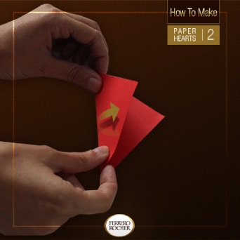 Fold the squares in half by matching two opposite corners.